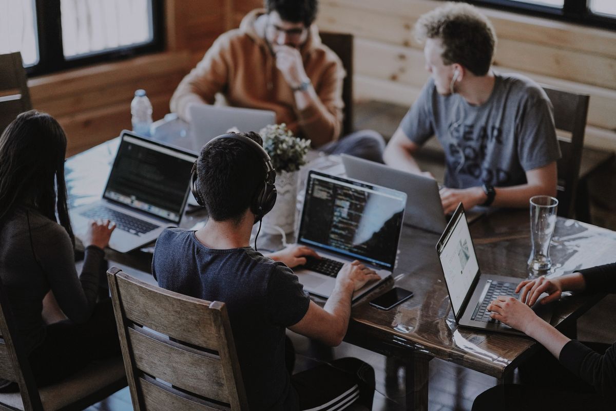 Team working on laptops, real help 24/7